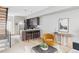 Open-concept kitchen with a breakfast bar, wooden cabinetry, and stairs leading to the upper level at 4485 Tennyson St # 5, Denver, CO 80212