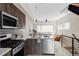 Bright kitchen with modern appliances, wood-look cabinets, light countertops, and a view of the living area at 4485 Tennyson St # 5, Denver, CO 80212