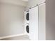 Modern laundry room featuring a stacked washer and dryer hidden behind a sliding door at 4485 Tennyson St # 5, Denver, CO 80212