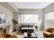 Bright living room features hardwood floors, large windows, comfortable seating, and modern decor at 4485 Tennyson St # 5, Denver, CO 80212