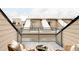 Rooftop deck with modern railing, outdoor seating, and views of neighboring townhomes at 4485 Tennyson St # 5, Denver, CO 80212