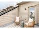 Cozy outdoor seating area features wicker chairs and a striped rug on a private balcony at 4485 Tennyson St # 5, Denver, CO 80212