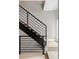 Modern staircase with black steel railings, wooden stairs, and light hardwood floors at 4485 Tennyson St # 5, Denver, CO 80212