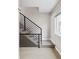 Modern staircase features neutral-colored carpet and a black metal railing for a sleek design at 4485 Tennyson St # 5, Denver, CO 80212