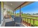Covered balcony overlooking a lush green field with comfortable outdoor seating at 5260 Garrison St # 11, Arvada, CO 80002