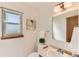 Bright bathroom featuring a white sink, vanity, artwork and a window at 5260 Garrison St # 11, Arvada, CO 80002