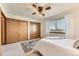 This bedroom features neutral carpet, ceiling fan, two closets and a window at 5260 Garrison St # 11, Arvada, CO 80002