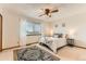 Comfortable bedroom features neutral decor, ceiling fan, and natural light from the window at 5260 Garrison St # 11, Arvada, CO 80002