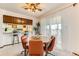 Cozy dining area features a wooden table, orange chairs, and sliding glass door to balcony at 5260 Garrison St # 11, Arvada, CO 80002