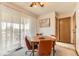 View of dining room with orange chairs, area rug and sliding glass doors to a balcony at 5260 Garrison St # 11, Arvada, CO 80002