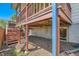 Back deck stairs, showing crawl space, and siding at 5260 Garrison St # 11, Arvada, CO 80002