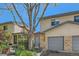 Charming townhome exterior with a well-kept lawn, a brick facade, and an attached garage at 5260 Garrison St # 11, Arvada, CO 80002