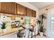 Charming kitchen bar featuring stainless steel sink, barstool seating and plant at 5260 Garrison St # 11, Arvada, CO 80002