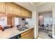 Kitchen with stainless steel sink and a view into the living room at 5260 Garrison St # 11, Arvada, CO 80002