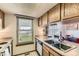 Kitchen with a stainless steel sink, a window and wood cabinets at 5260 Garrison St # 11, Arvada, CO 80002
