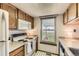 Bright kitchen featuring tile floors and a garden view at 5260 Garrison St # 11, Arvada, CO 80002