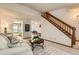 Bright living room featuring an open floor plan, staircase, and view of the kitchen at 5260 Garrison St # 11, Arvada, CO 80002