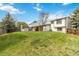 Wide backyard showcasing a lush lawn, storage shed, and a covered patio attached to the home at 10550 Routt St, Westminster, CO 80021
