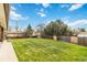 Beautiful grassy backyard is surrounded by a wood fence for privacy at 10550 Routt St, Westminster, CO 80021