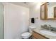Cozy bathroom featuring a granite countertop vanity, a tiled half-wall, and a standard toilet and shower at 10550 Routt St, Westminster, CO 80021