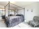 Bedroom with four-poster bed, patterned accent chair and double mirror closet at 10550 Routt St, Westminster, CO 80021