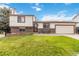 Charming two-story home featuring a well-manicured front lawn and attached two car garage at 10550 Routt St, Westminster, CO 80021
