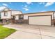Two-story home featuring a two-car garage and a front patio seating area at 10550 Routt St, Westminster, CO 80021