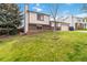 Two-story home featuring a well-manicured front lawn with a brick facade at 10550 Routt St, Westminster, CO 80021