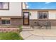 A well-maintained front exterior featuring brick accents and an outdoor seating area at 10550 Routt St, Westminster, CO 80021