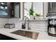 Close-up of kitchen sink features subway tile backsplash and stainless steel appliances at 10550 Routt St, Westminster, CO 80021