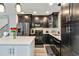 Charming kitchen boasts dark cabinets, stainless steel appliances, and a bright white center island at 10550 Routt St, Westminster, CO 80021