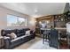 Cozy living room with leather sofa, fireplace and wet bar at 10550 Routt St, Westminster, CO 80021
