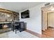 Cozy living room with a fireplace, bar area, mounted TV, and entrance to an adjacent room at 10550 Routt St, Westminster, CO 80021