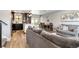 Spacious living room connected to the kitchen and dining area with modern design at 10550 Routt St, Westminster, CO 80021
