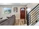 Cozy living room with modern staircase, wood flooring, and natural light from a window at 10550 Routt St, Westminster, CO 80021