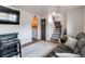 Inviting living room featuring a modern television, bar, and access to the upstairs and a convenient laundry area at 10550 Routt St, Westminster, CO 80021