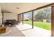 Covered patio with outdoor seating overlooks a spacious yard with lush greenery and a privacy fence at 10550 Routt St, Westminster, CO 80021