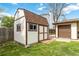 White and brown shed with matching trim in the backyard with a brick walkway at 10550 Routt St, Westminster, CO 80021
