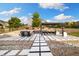 Beautiful backyard with a tiled patio area, featuring a pergola and seating area with stone surround at 6692 S Robertsdale Way, Aurora, CO 80016