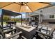 Gorgeous backyard featuring a modern patio with a fire pit, pergola, and comfortable seating at 6692 S Robertsdale Way, Aurora, CO 80016