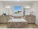 Luxurious bathroom featuring a soaking tub and dual vanities at 6692 S Robertsdale Way, Aurora, CO 80016