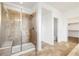 Bathroom featuring tiled shower with glass door and tiled floor at 6692 S Robertsdale Way, Aurora, CO 80016