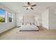 Inviting main bedroom with plush neutral carpet, ceiling fan, and stylish decor at 6692 S Robertsdale Way, Aurora, CO 80016