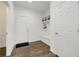 Bright entryway featuring a bench, coat rack, and wood-look flooring at 6692 S Robertsdale Way, Aurora, CO 80016