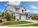 Stylish two-story home with stone accents, three-car garage, and landscaped front yard at 6692 S Robertsdale Way, Aurora, CO 80016