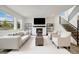 Cozy living room featuring a modern fireplace, hardwood floors, a comfortable sofa, and a staircase at 6692 S Robertsdale Way, Aurora, CO 80016