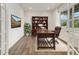 Bright home office featuring French doors, hardwood floors, a window, and built in book shelves at 6692 S Robertsdale Way, Aurora, CO 80016