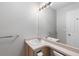 Well-lit bathroom featuring a sink, mirror, and clean, neutral decor at 6450 W 44Th Pl # B3, Wheat Ridge, CO 80033