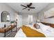 Bedroom features a ceiling fan, stylish decor, and two entry doors at 6450 W 44Th Pl # B3, Wheat Ridge, CO 80033