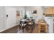This dining area boasts a stylish table, six chairs, and natural light from a nearby window at 6450 W 44Th Pl # B3, Wheat Ridge, CO 80033